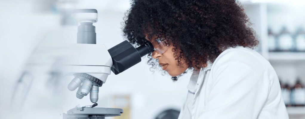 Researcher looking in microscope