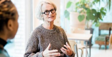 An older woman speaks in a support group